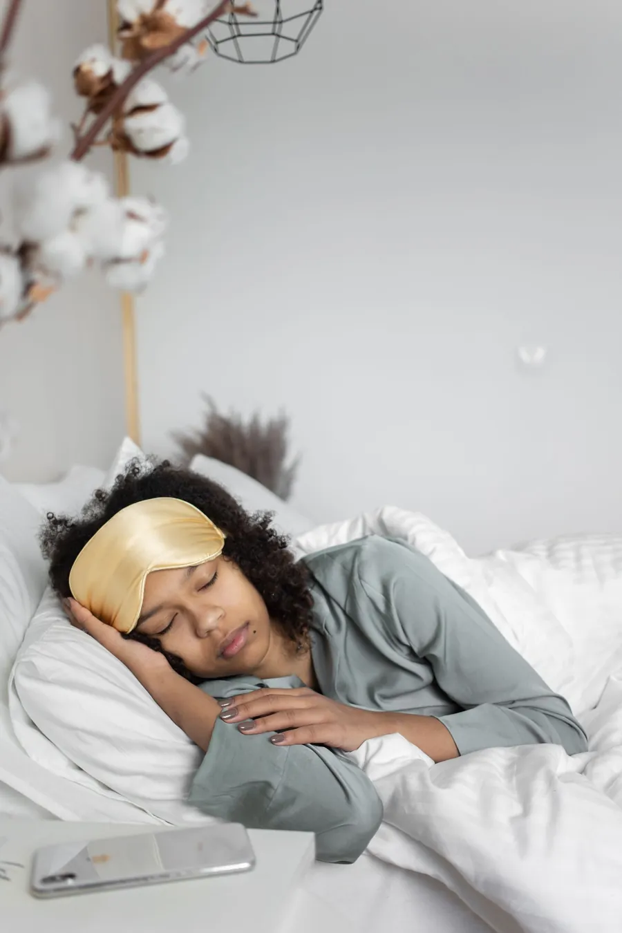 Fall asleep fast in the dark: woman sleeping with a silk sleep mask